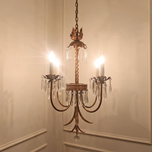 A French gilt toleware antique chandelier with four arms and crystal glass icicle droplets