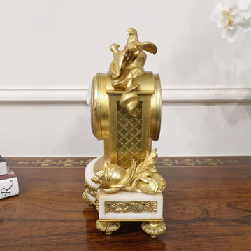 an antique French Louis XIV style bronze gilt ormolu mantel clock with two doves to the top and white enamel dial