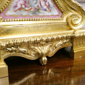A French Louis XV style antique mantel clock with gilt bronze case and porcelain panels, by Jean Baptiste Delettrez