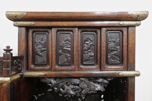 an antique Japanese Meiji Period shodana display cabinet with silver inlay and carving of landscapes, birds and flowers. There are sliding doors, staggered shelving and drawers