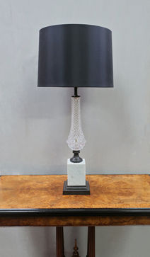 a vintage French table lamp with glass and bronze body stood on square white carrara marble bases