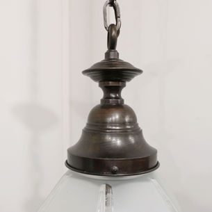 An Art Deco antique pendant light with hexagonal shaped frosted glass body and bronzed gallery, hanging on an adjustable chain with ceiling rose.