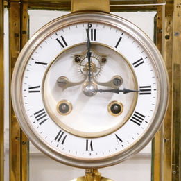 French late 19th century oval shaped four glass mantel clock with bevelled glass panels, brass frame and gilt bronze mounts. The movement is by Samuel Marti and strikes on a bell.