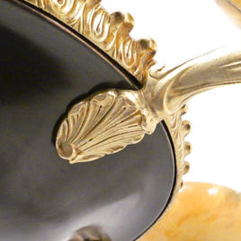 An Art Deco period bronze chandelier in the Empire Style with gilt bronze arms terminating to alabaster shades