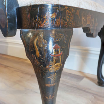 an antique Victorian black lacquered armchair in the Queen Anne style with chinoiserie oriental hand painted designs and raised gesso detail with trees and flowers standing on shaped cabriole legs and drop in upholstered seat