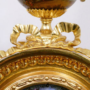 French Louis XVI style gilt bronze antique mantel clock with hand painted porcelain panels. The movement strikes on a bell by Japy Freres