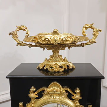 French 19th century polished black slate mantel clock with scrolling bronze gilt rococo style mounts and moulds. The movement is stamped with the maker Japy Freres and strikes on a bell