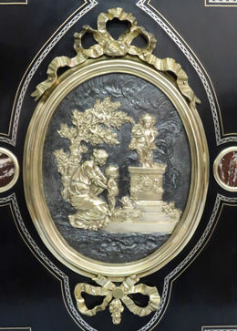 a decorative antique French Louis Philippe ebonised double doored side cabinet attributed to Georges  Monbro with bronze gilt ormolu mounts and lapis lazuli inlay