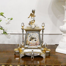 French silver mantel clock in the Egyptian style with pocelain panels and movement by Ricard et cie