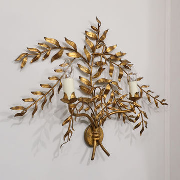 A vintage Italian Hollywood Regency style Mid-Century gilt metal two arm wall light sconce formed as leaves and branches