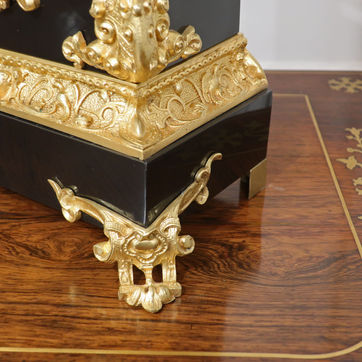 French 19th century polished black slate mantel clock with scrolling bronze gilt rococo style mounts and moulds. The movement is stamped with the maker Japy Freres and strikes on a bell