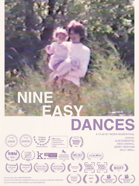 An image shows a woman holding a small child. The background is filled with trees and tall grasses.