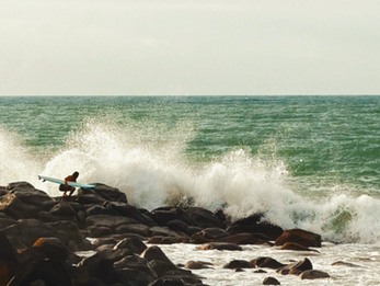 Surfer is waiting for the right time to jump in the water between sets.