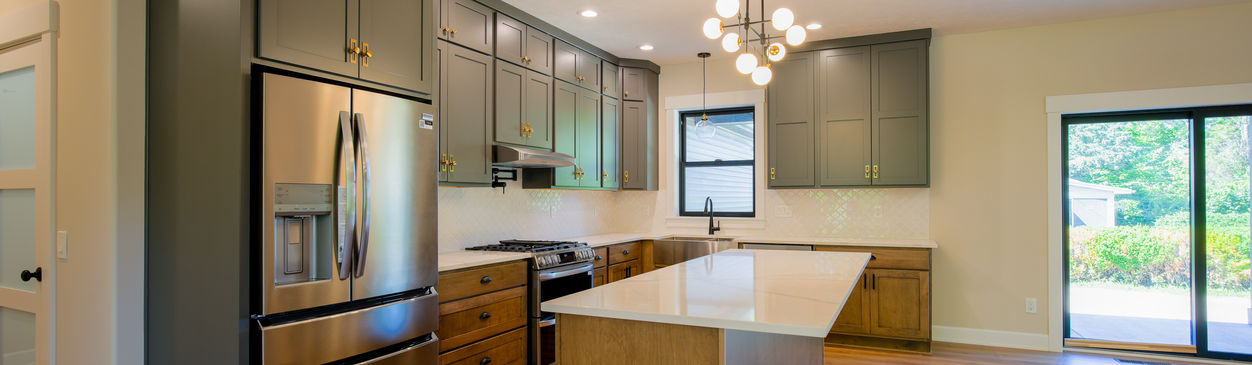 Modern kitchen with stainless steel appliances.