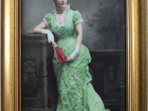 ITEM # 245, FRAMED PORCELIAN PLAQUE OF WOMAN IN GREEN GOWN: