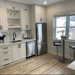 Modern kitchen with white cabinets and stainless steel appliances; DurhamFlooring.ca