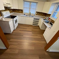 Kitchen with new flooring and white cabinets. Get Your Free Estimate for renovations.