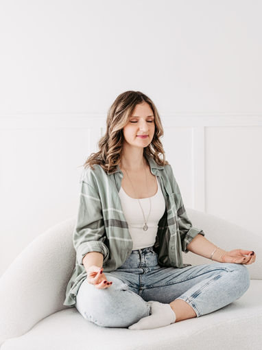 Woman practicing breathwork to regulate her nervous system in a peaceful setting.