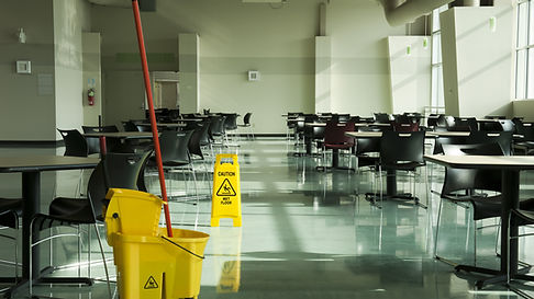 A mop, bucket and caution sign in a cafe