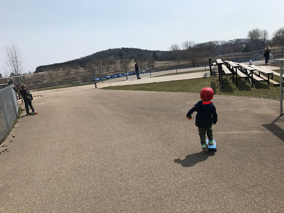 The boys skateboard in a 'quiet' area of the advanced track. They can watch their dad drift while they play. DD85