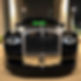 rolls royce black in houston texas at night.