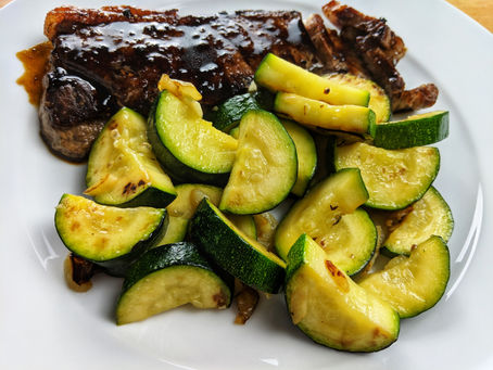 New York strip steak with red wine reduction and Zucchini
