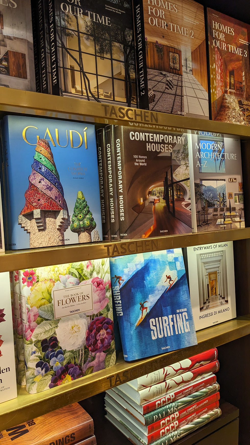 Books displayed on shelves of Taschen's London vibrant bookstore.