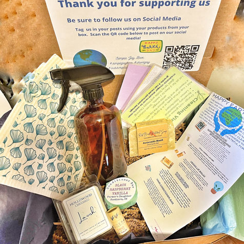 subscription box containing a shampoo bar, conditioner bar, vegan lip balm, washclouds, wax melts, DIY cleaning solution recipes, glass spray bottle