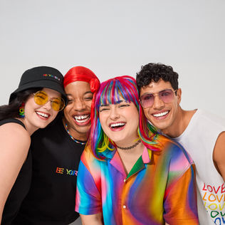 Close up of 4 models smiling with heads together wearing the Hope & Wonder Pride 24 collection