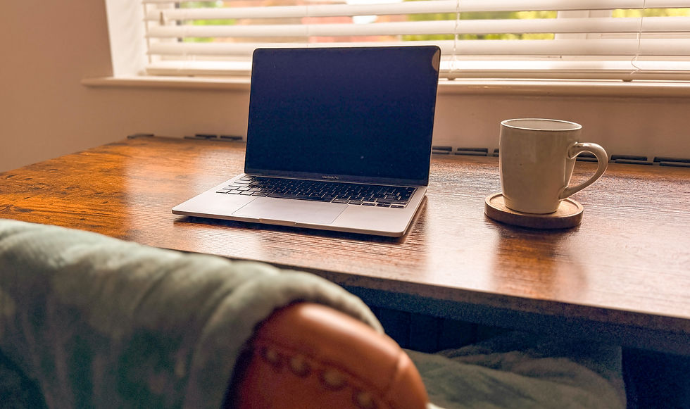 Laptop, blanket, and tea in a calm home setting for online therapy