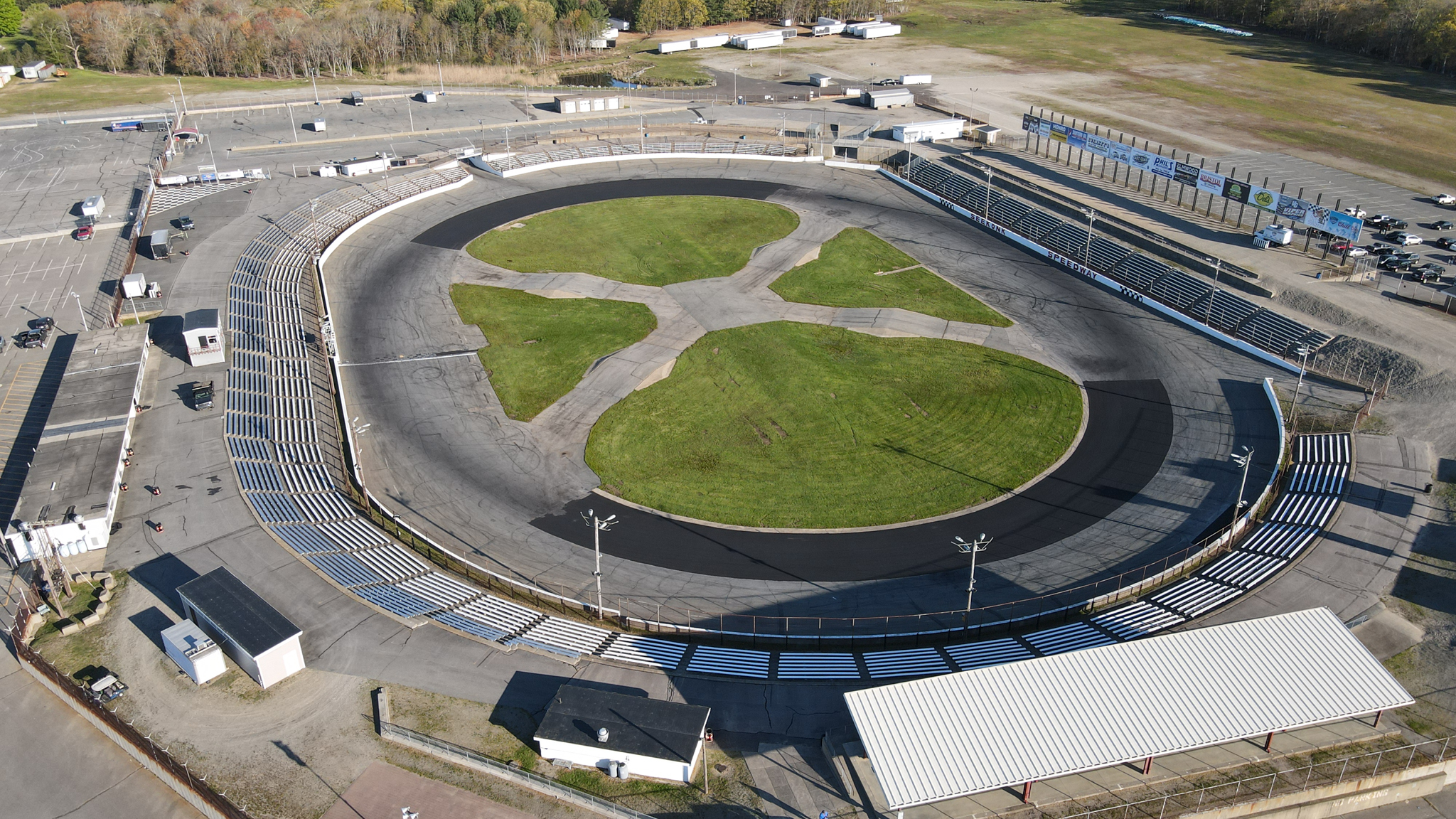 Cars roaring around the asphalt under the lights at Seekonk Speedway