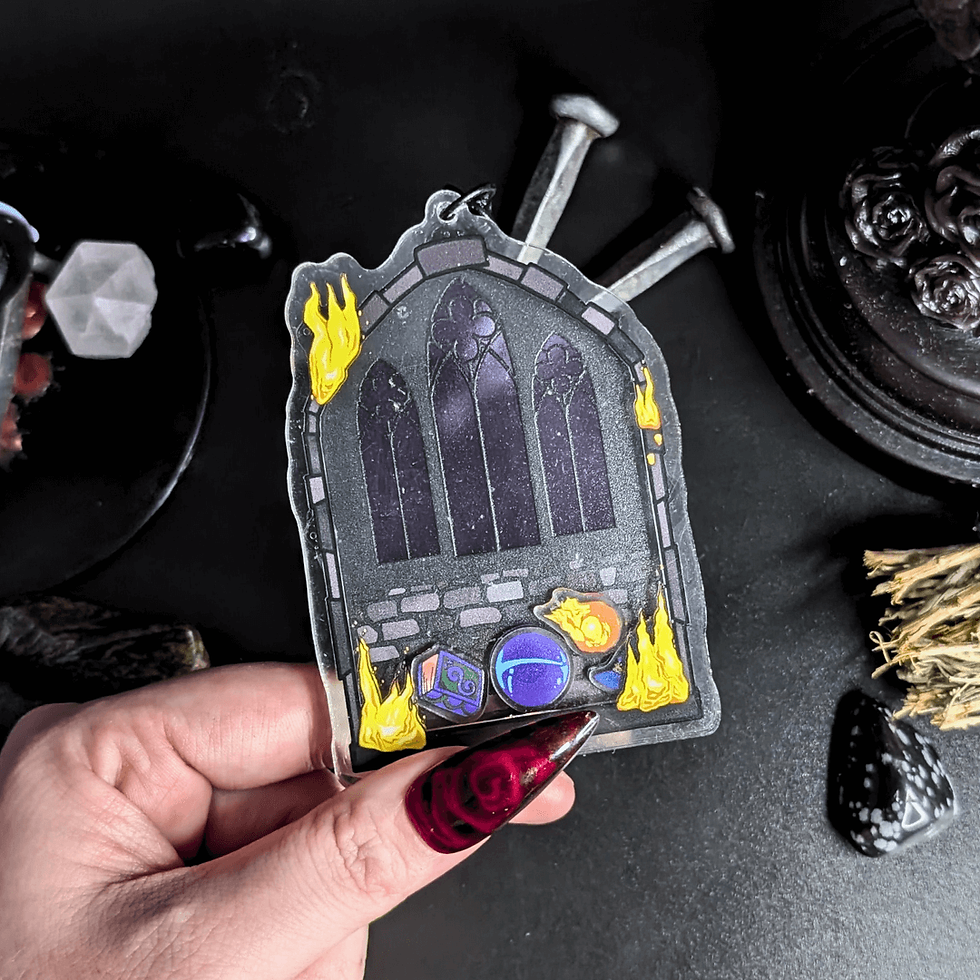 Hand holding Gothica keychain. Black gothic style design with flames. Roll Gothica.