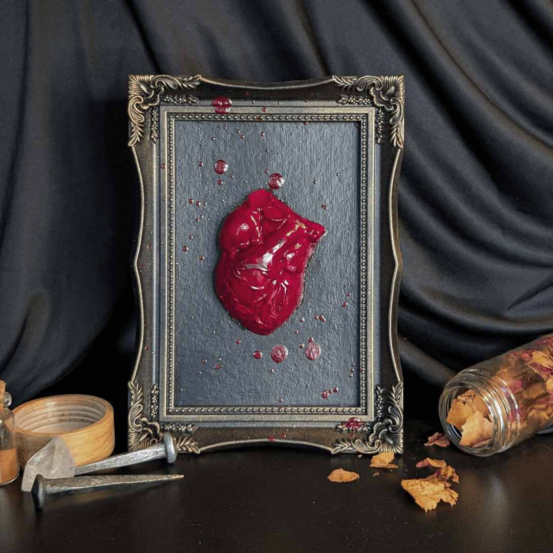 A heart-shaped sculpture in a frame with blood details, Roll Gothica.