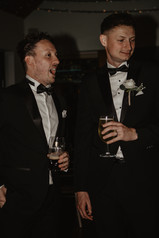 groom and groomsman enjoying the reception drinks at canada lodge
