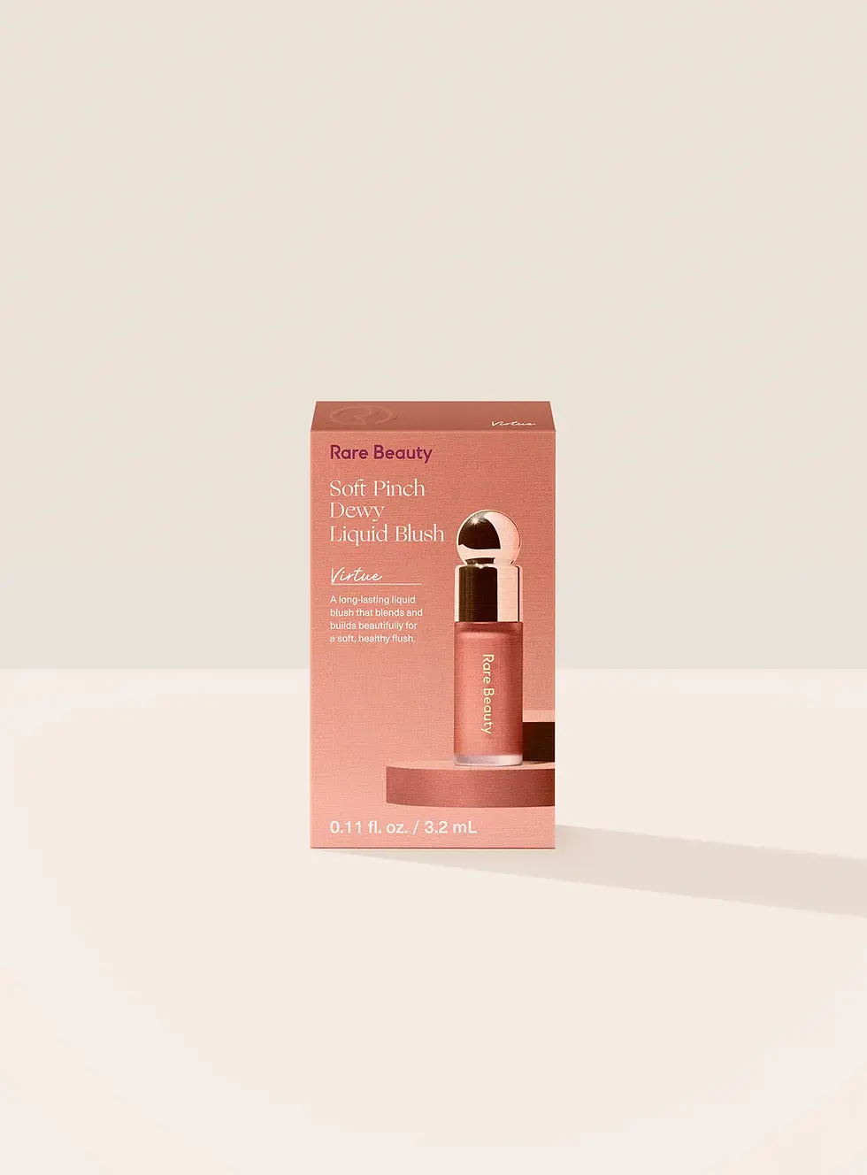 Miniatura: Rubor líquido Rare Beauty Soft Pinch Mini Virtue en tono melocotón, ideal para un maquillaje cálido y natural.