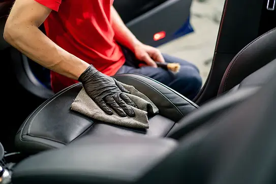 Man_Cleaning_Car_Seat.webp