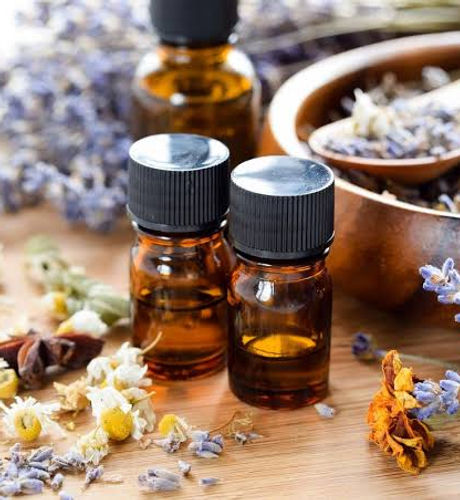 Essential oils in bottles and dried flowers