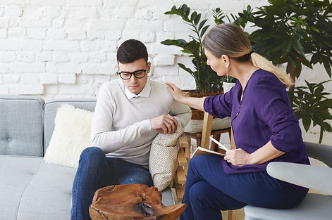 candid-shot-casually-dressed-professional-woman-psychotherapist-her-fifties-touching-her-y