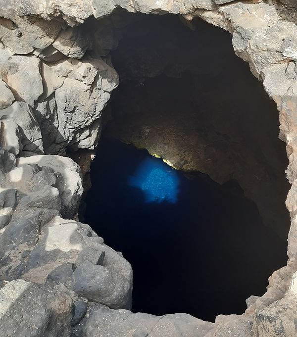 Weedon & Co, The Blue Eye at Buracona, Sal, showing glowing turquoise water in a volcanic cave.
