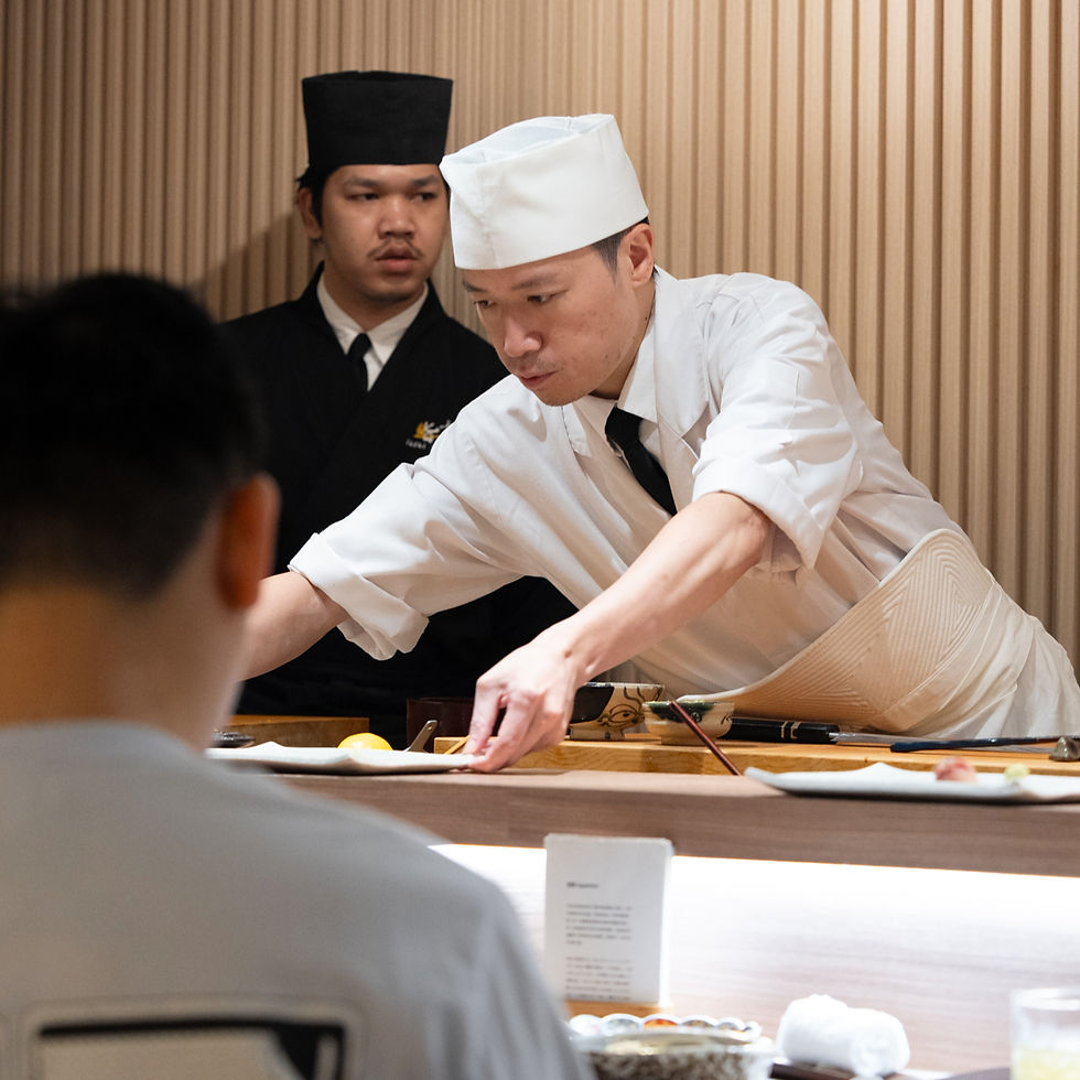 Master sushi chef preparing fresh nigiri at the exclusive Omakase counter of Sushi Yorokobu BKK in Bangkok, demonstrating the Edomae dining experience.