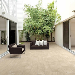 a patio with beige porcelain pavers