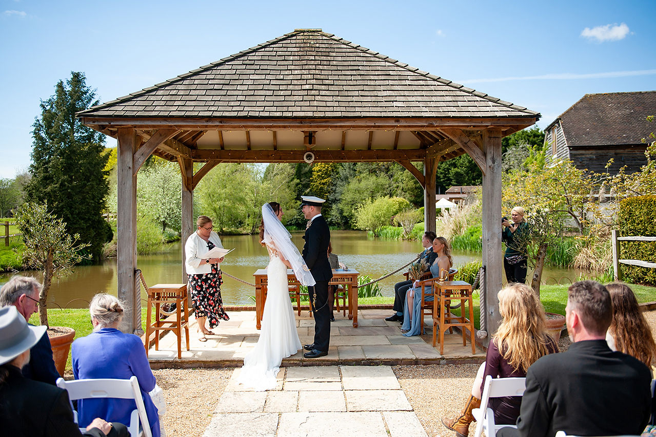 Bride and groom exchanging rings during their wedding ceremony at Brookfield Barn, capturing a moment of love and commitment.