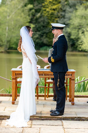 Bride and groom exchanging vows during their wedding ceremony at Brookfield Barn, sharing heartfelt promises with each other.