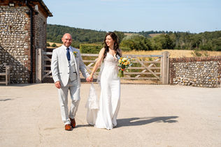 Married couple walking together and holding hands at Farbridge Wedding Venue