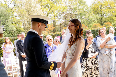 Bride and groom exchanging vows during their wedding ceremony at Brookfield Barn, sharing heartfelt promises with each other.