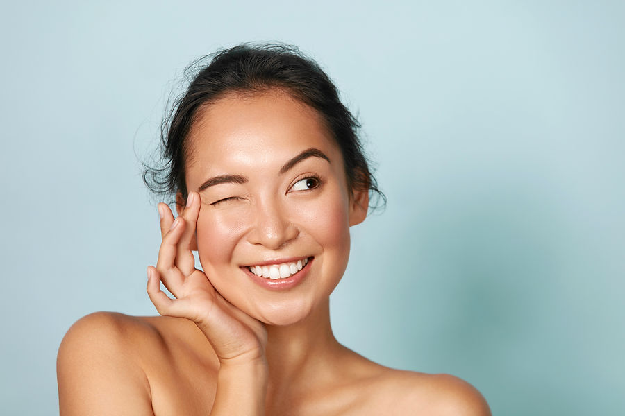 Woman with beauty face touching healthy facial skin portrait