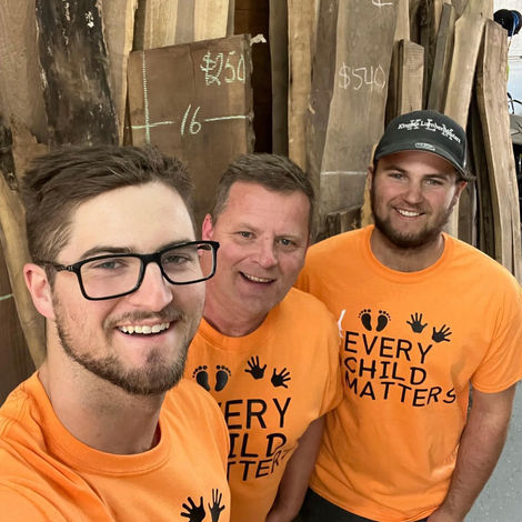 Three man in orange t-shirts taking a selfie