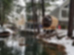 Vue élargie d'un sauna panoramique installé au bord de l'eau en hiver