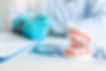Close up dentures with dentist working on table in clinic