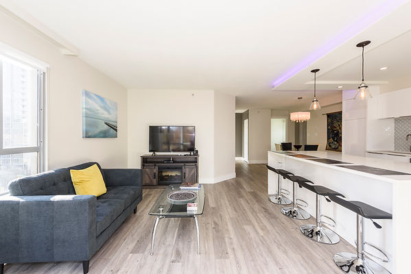 living space with sofa, countertops, and TV